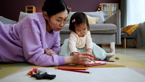 Asian mother playing with her baby