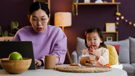 Asian mother with her baby in living room