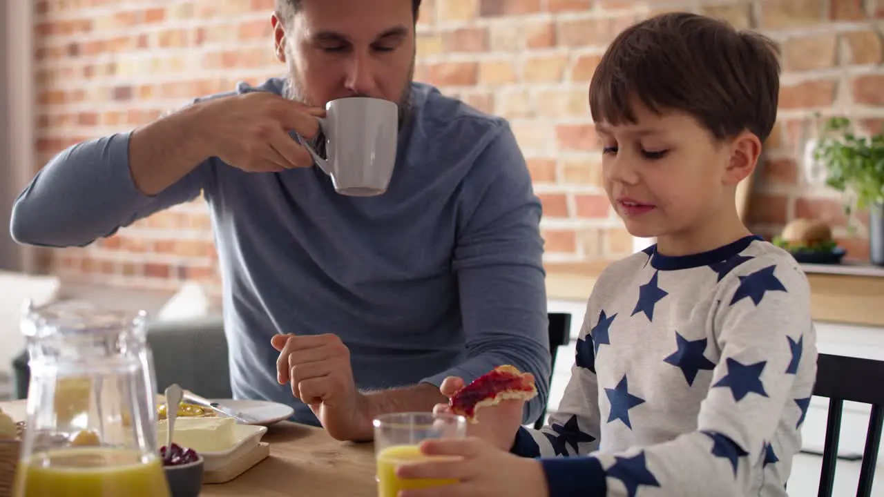 Video of father and son eating breakfast together at the morning