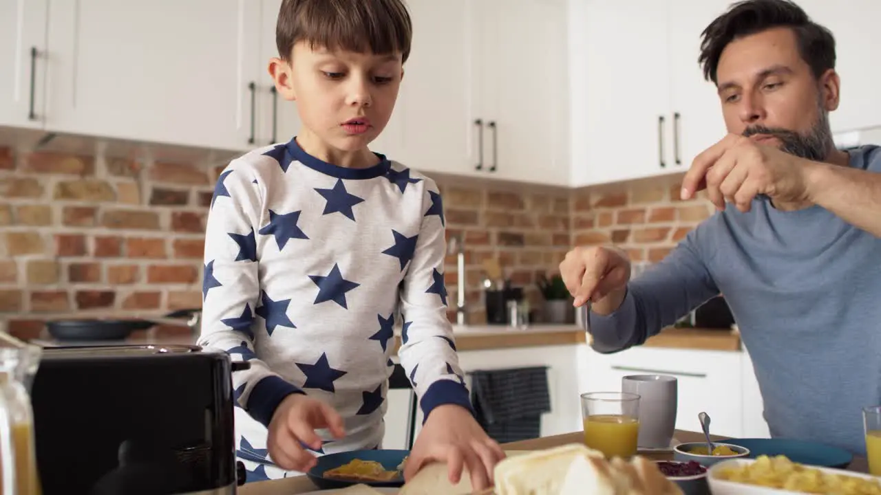 Video of son and father having breakfast in the morning