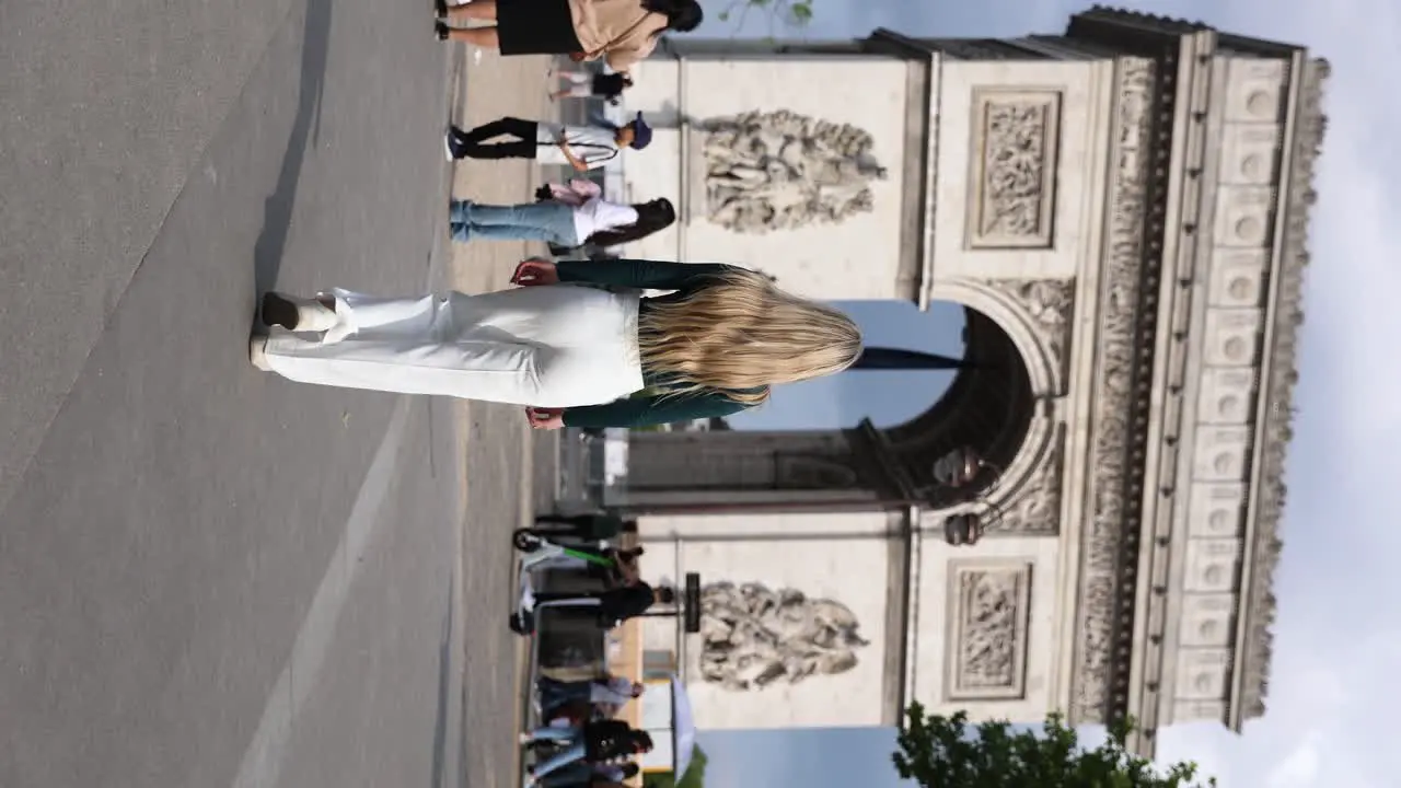 Woman Tourist in Paris Walking towards Arc de Triomphe in City Streets