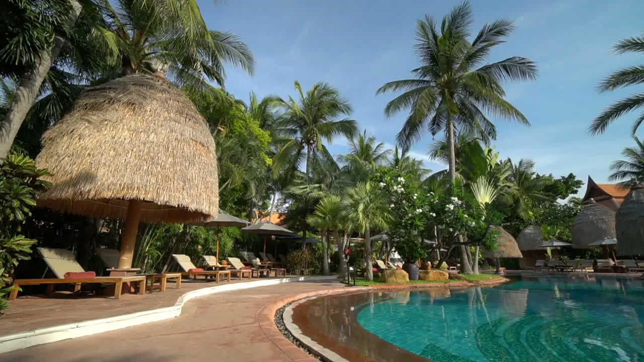 Thailand Circa swimming pool at a luxury hotel resort in Thailand with coconut palm trees overlooking the water