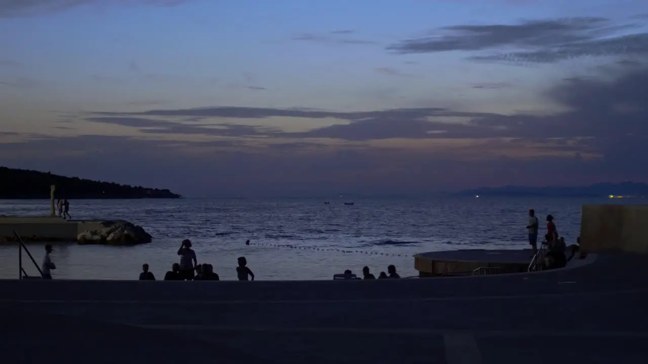 People enjoying the late evening sun over the Adriatic along the coast of Postira