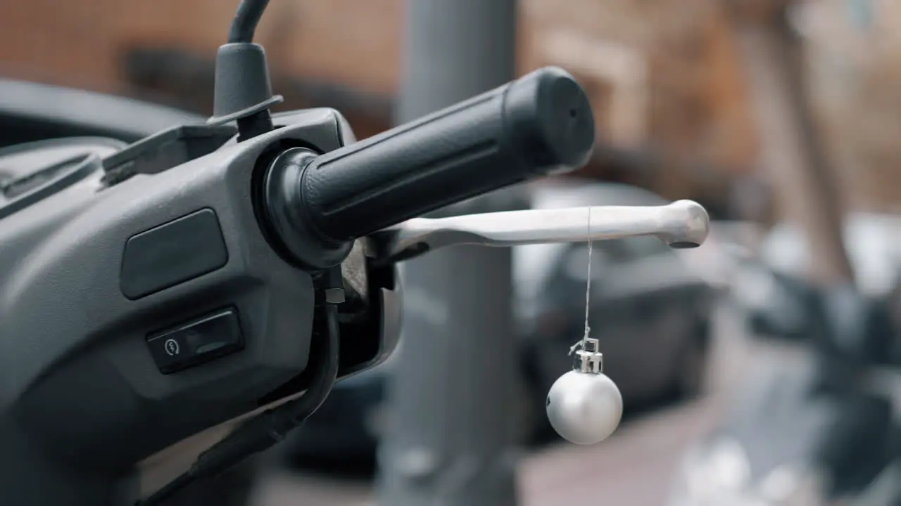 Christmas ball hanging on scooter handlebar