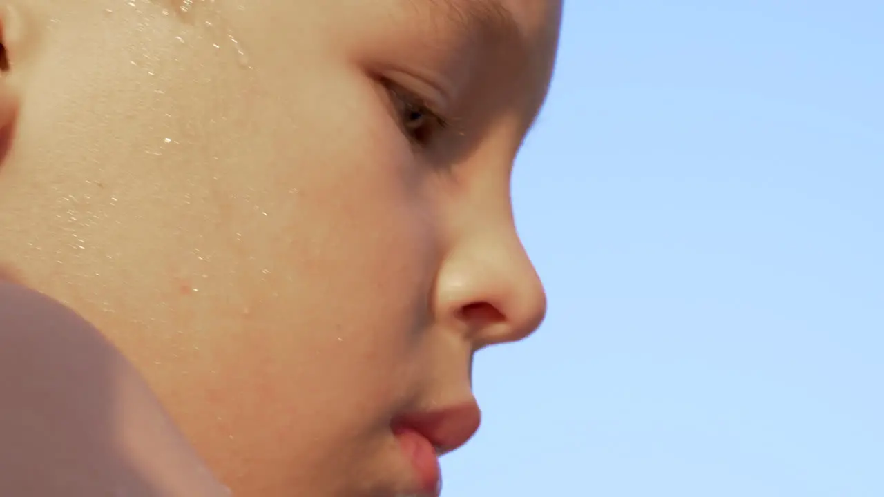 Portrait of boy in the light of warm sun against blue sky