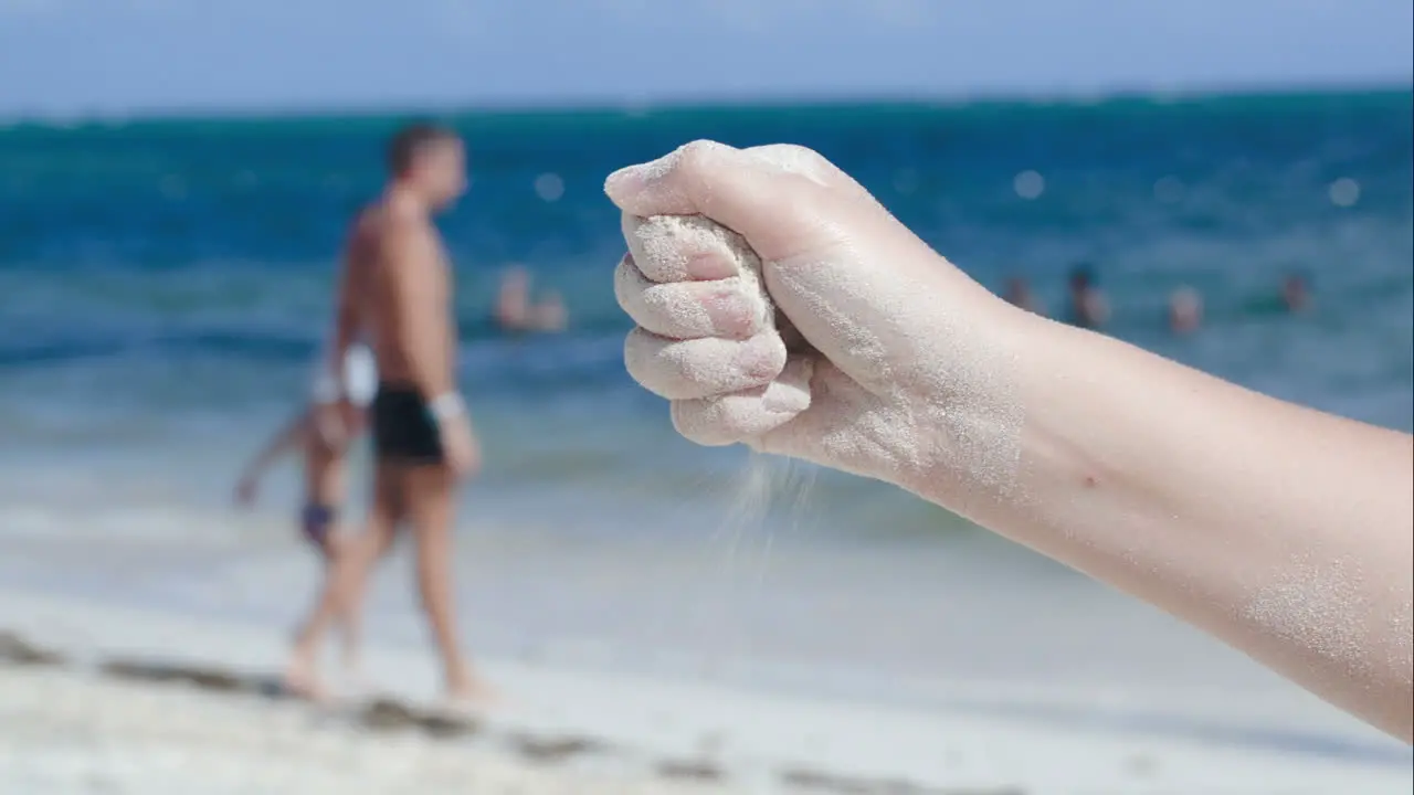 Sand pouring from female hand