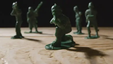 Tracking Shot Pulling Away from Handful of Toy Soldiers