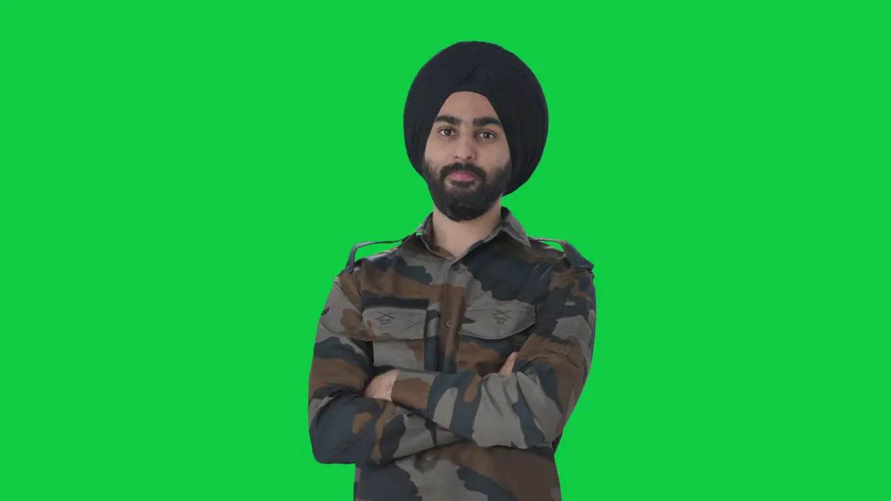 Confident Sikh Indian Army man standing crossed hands Green screen