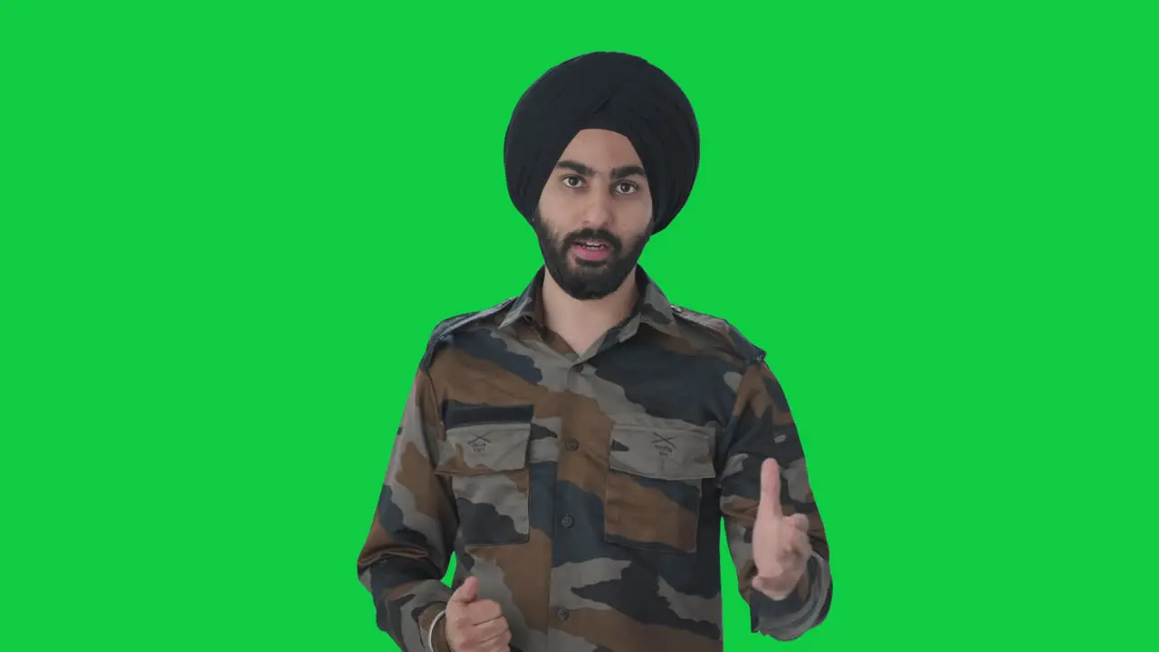 Serious Sikh Indian Army man talking to someone Green screen