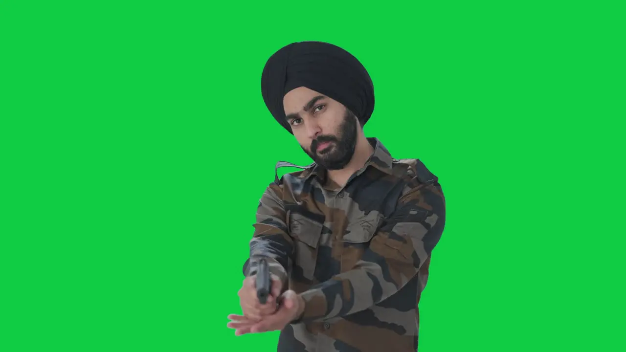 Sikh Indian Army man checking and pointing gun towards enemy Green screen