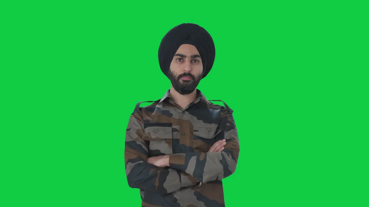 Serious Sikh Indian Army man looking at the camera Green screen