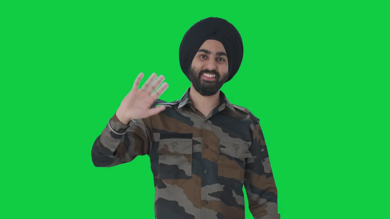 Happy Sikh Indian Army man saying Hello Green screen