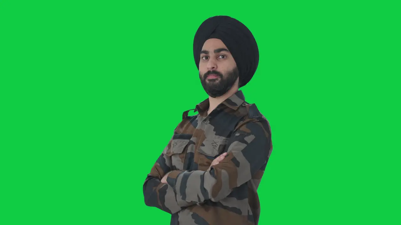 Portrait of Confident Sikh Indian Army man standing crossed hands Green screen