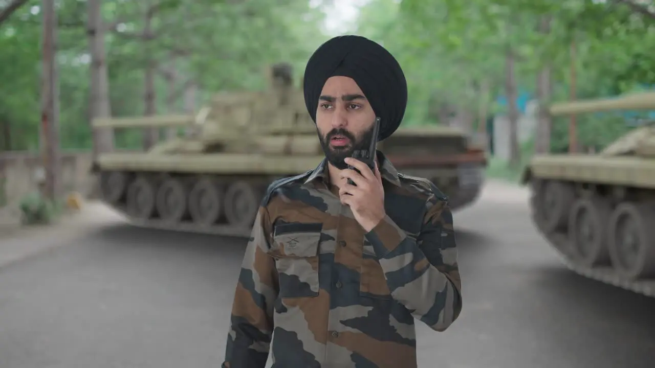 Serious Sikh Indian Army man giving instructions on walkie talkie