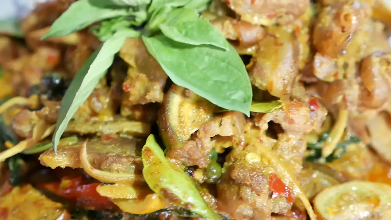 Close Up Footage of Thai Exotic Food Hot and Spicy Stir Fried Wild Boar With Kaffir Lime Leaves and Herbs