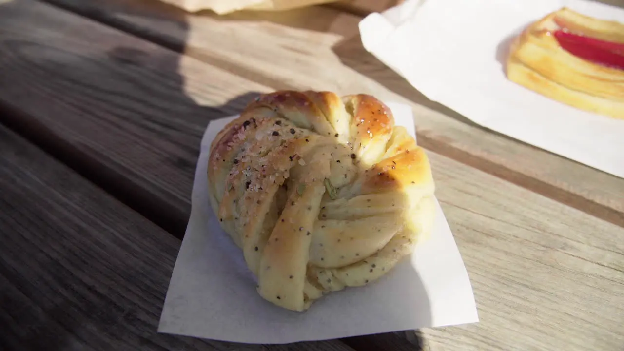 Freshly baked cardamom bun outside of a cafe in Scandinavia