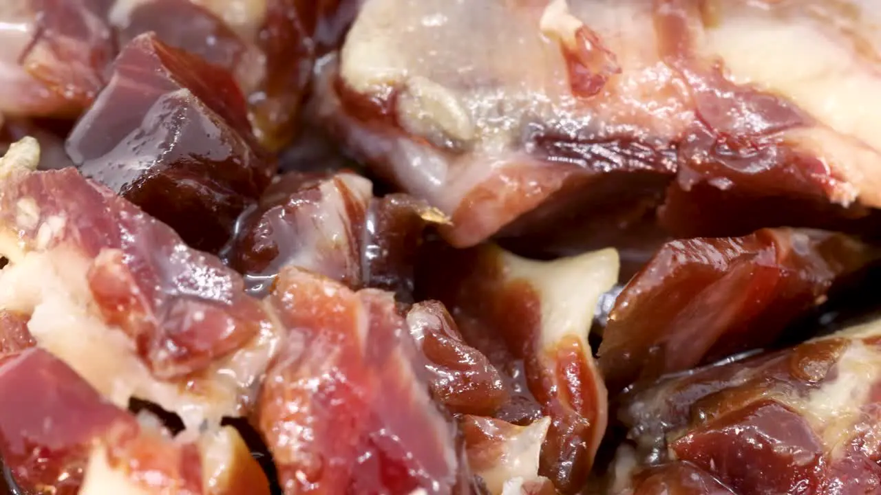 Macro shot of small serrano ham slices rotating