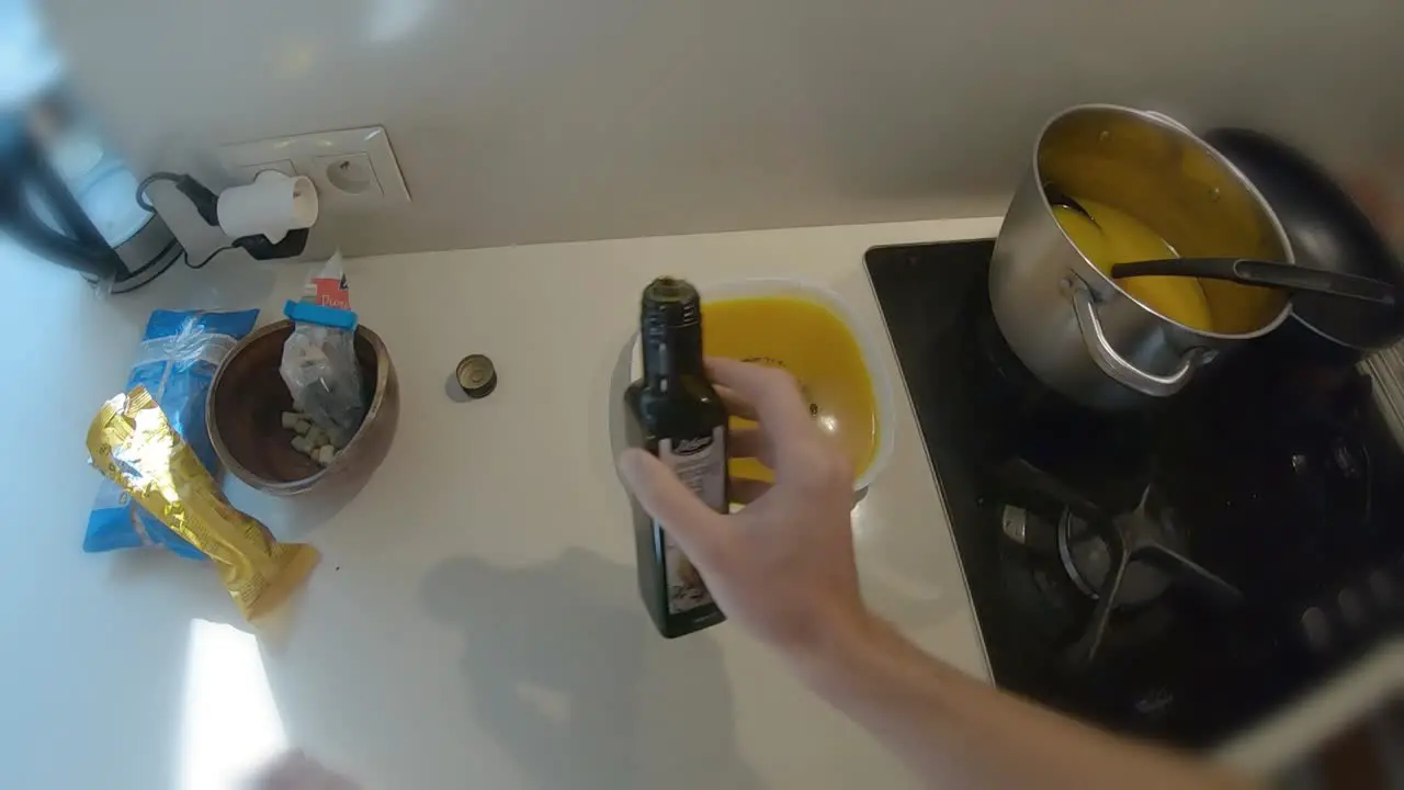 POV first person seasoning orange pumpkin soup