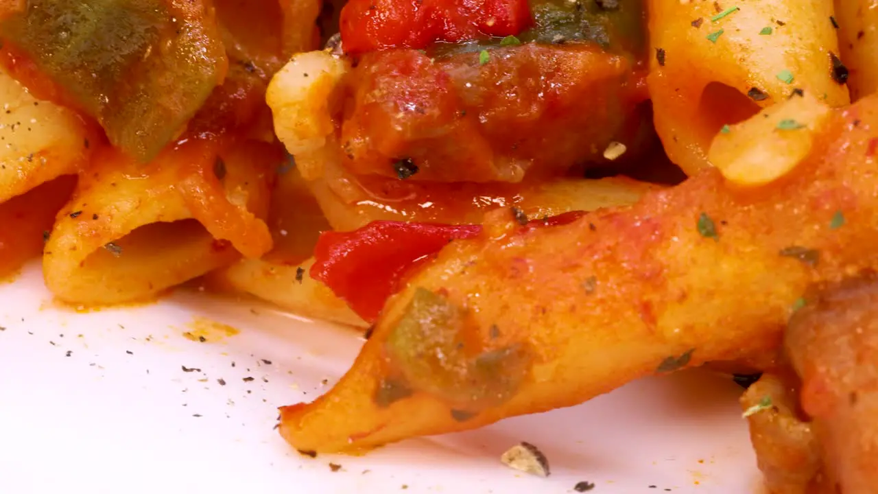 Macro shot of macaroni with red tomato and spices sauce rotating in 4k