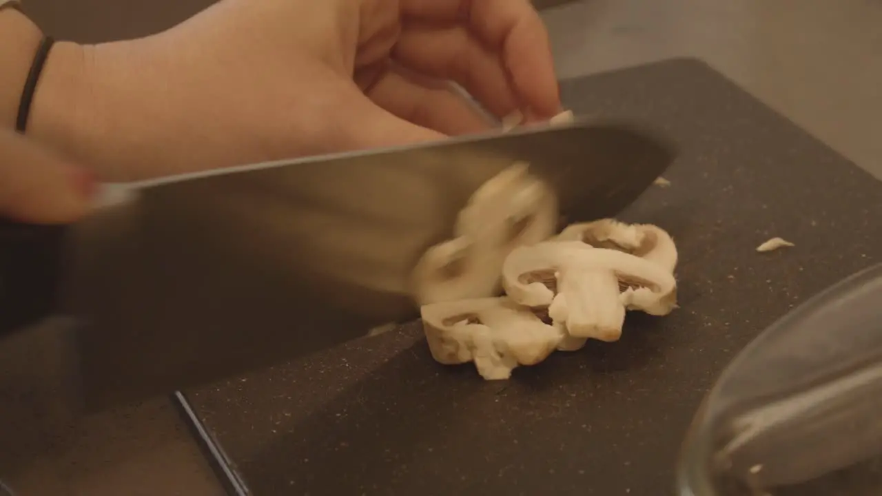 White mushrooms being chopped for dinner