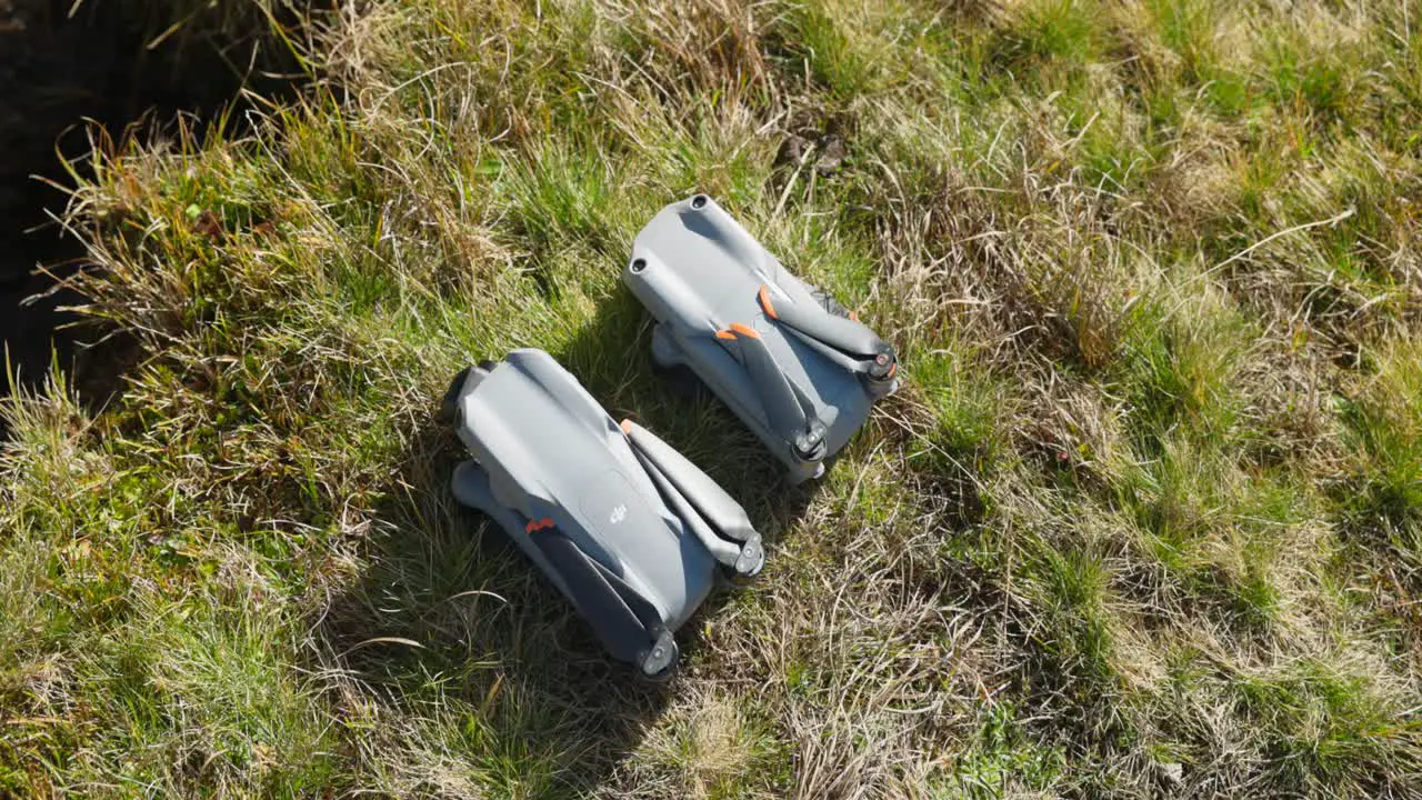 Overhead View of Folded DJI Air 2S And Air 3 On Grass For Side By Side Comparison