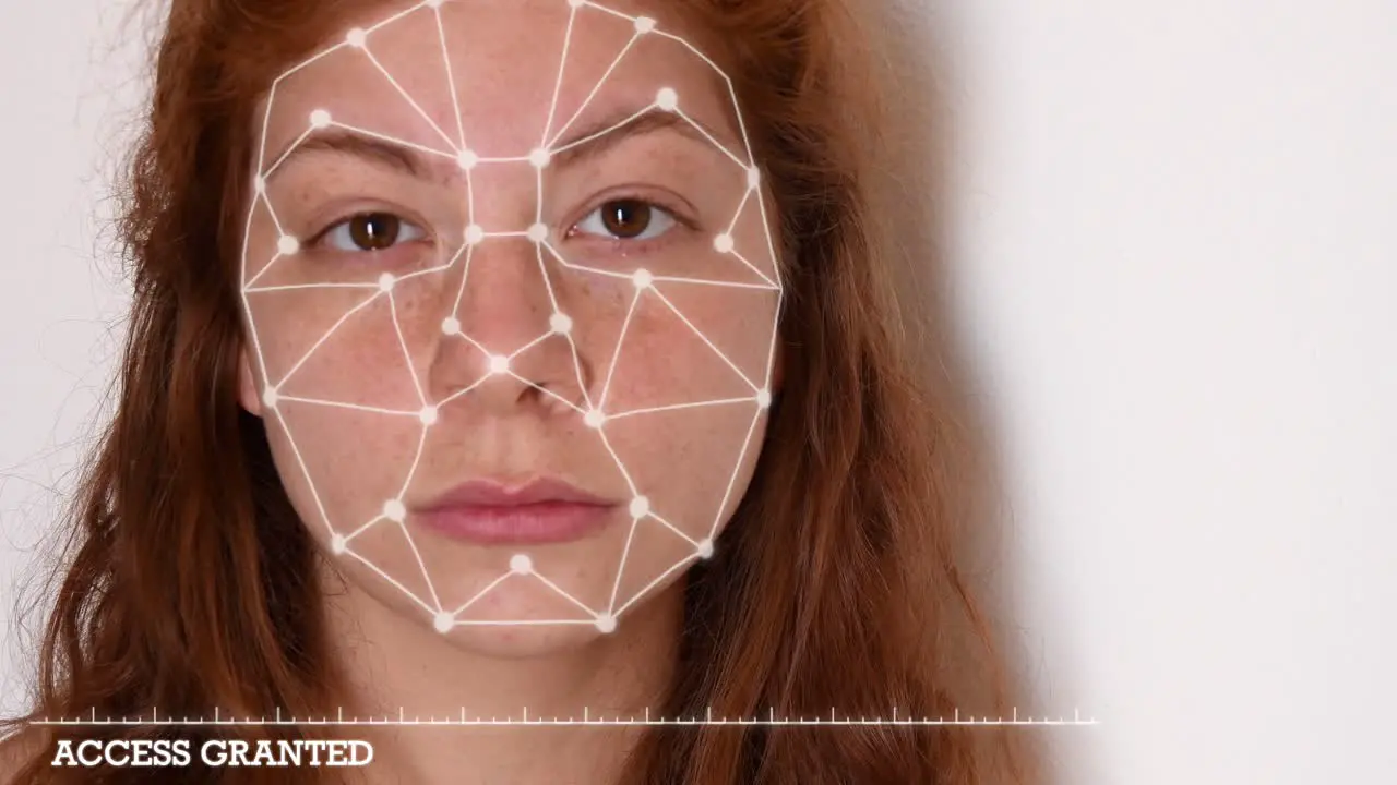 Close up of a young woman with red hair with a white shirt on a white background with facial recognition high tech animation with tracking points and a glow effect on her face with "access granted