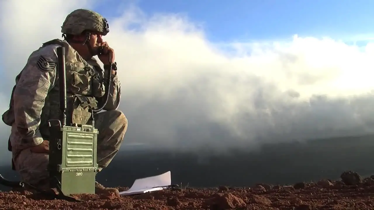 A Soldier Uses A Mobile Radio To Communicate During A Battle