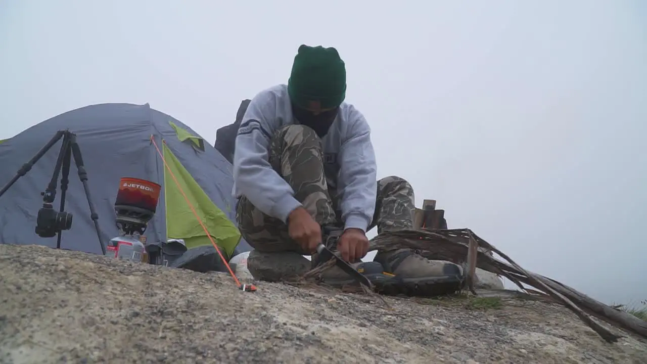 Camper Using Knife Cutting Tree Branch For Bonfire Obrajillo Lima Peru