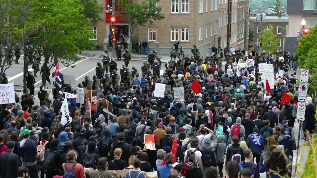 Police and army secure protest at G7 Summit crowd of people demonstratively walking