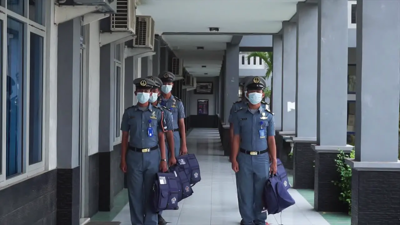 Male students or cadets of the Sailing and Maritime Vocational School line up and walk to class via the school terrace to attend lessons in the morning