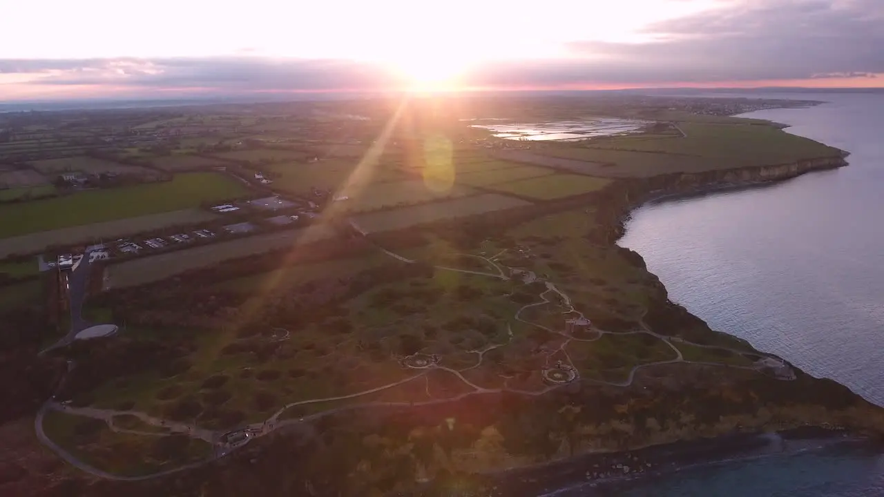 Back tracking over la Pointe du Hoc in Normandy during sunset Aerial drone shot