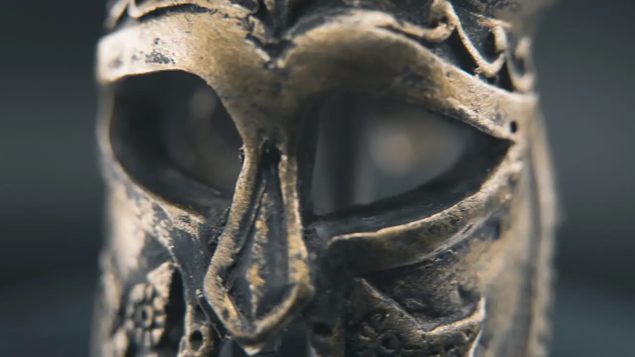 A close up macro detailed shot of a spartan face design warrior ancient greek bronze helmet on a 360 rotating stand studio lighting 4K smooth movement