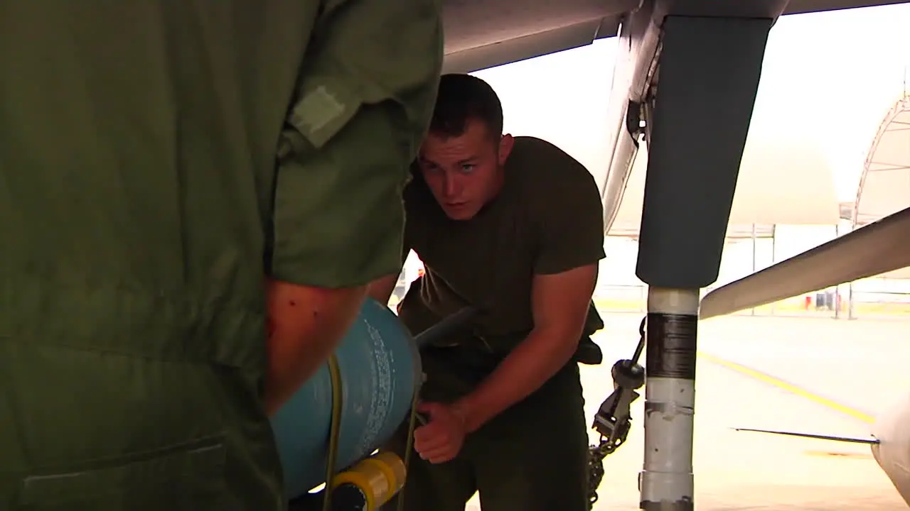 Bombs Are Loaded Onto A Jet Aircraft By Military Personnel 1