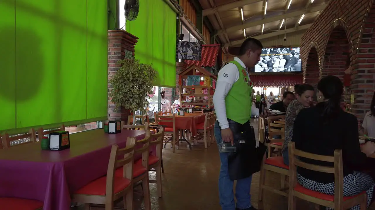 Waiter with a beer giving the check to a lady