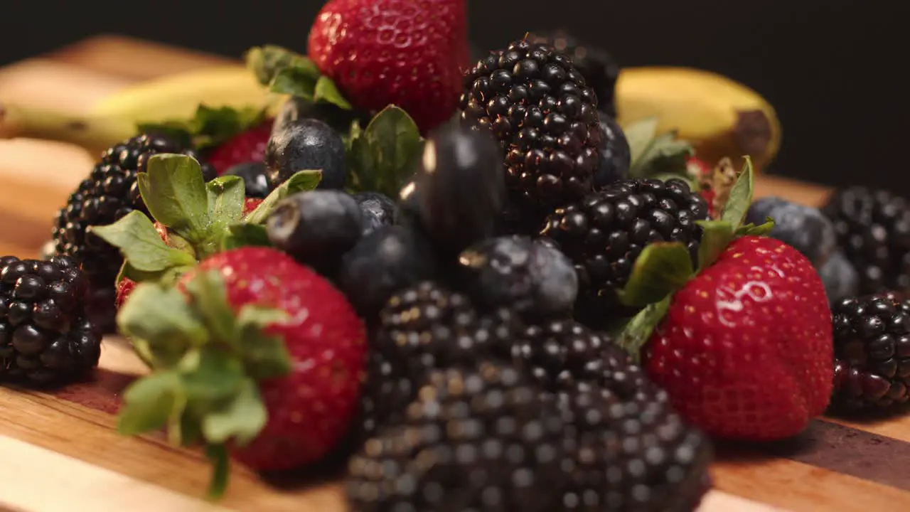 Fruit being dropped onto a cutting board full