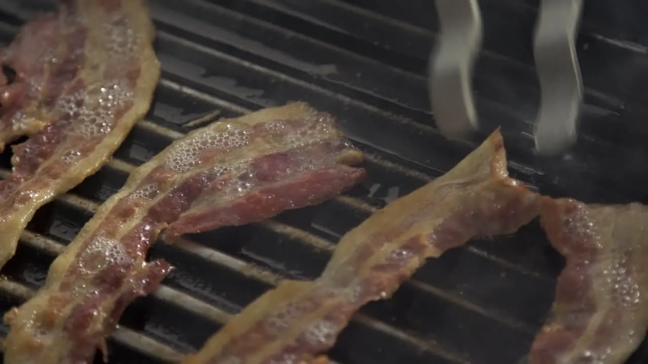 Grilling bacon pieces on hot pan