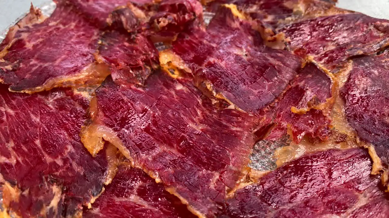 Delicious traditional Spanish Iberico pork cuts tasty delicatesse meat snack in Marbella Malaga Spain 4K panning right