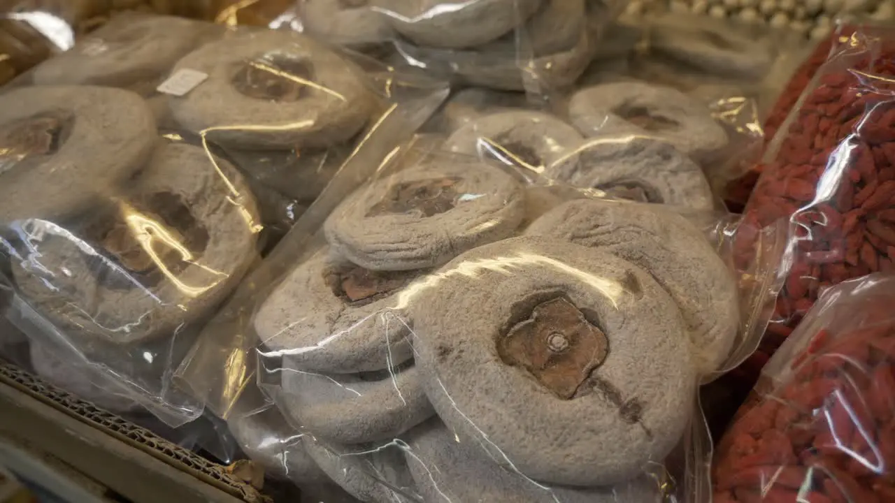 dried Persimmon cake in plastic bag for sale at Asian street food market documentary