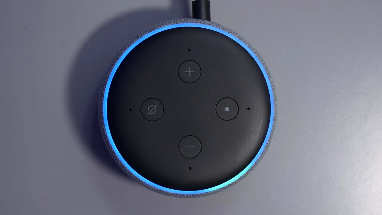 Overhead shot of smart speaker activated by voice command control with blue light ring