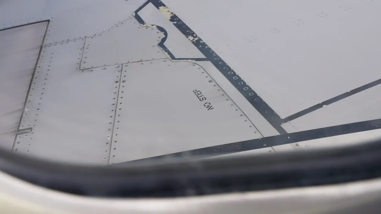 No Step Warning Sign On White Airplane Wing Seen From Passenger Window