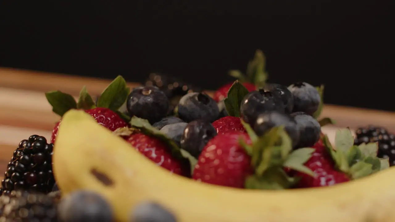 Blueberries being dropped onto a pile of spinning fruit