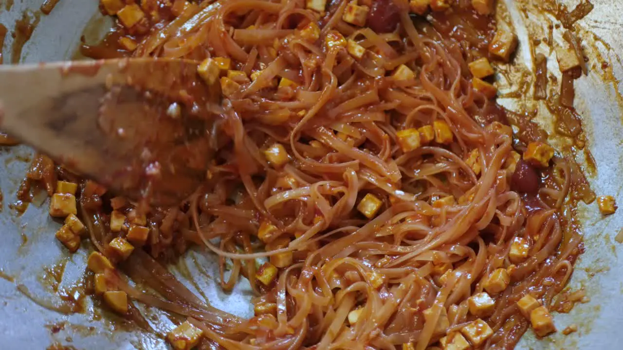 POV while cooking fry Pad Thai in kitchen