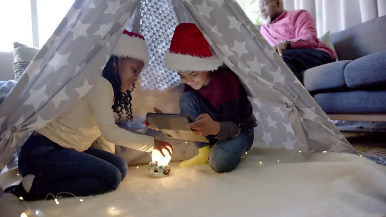 Montage of happy multi generation african american family at home together during christmas time