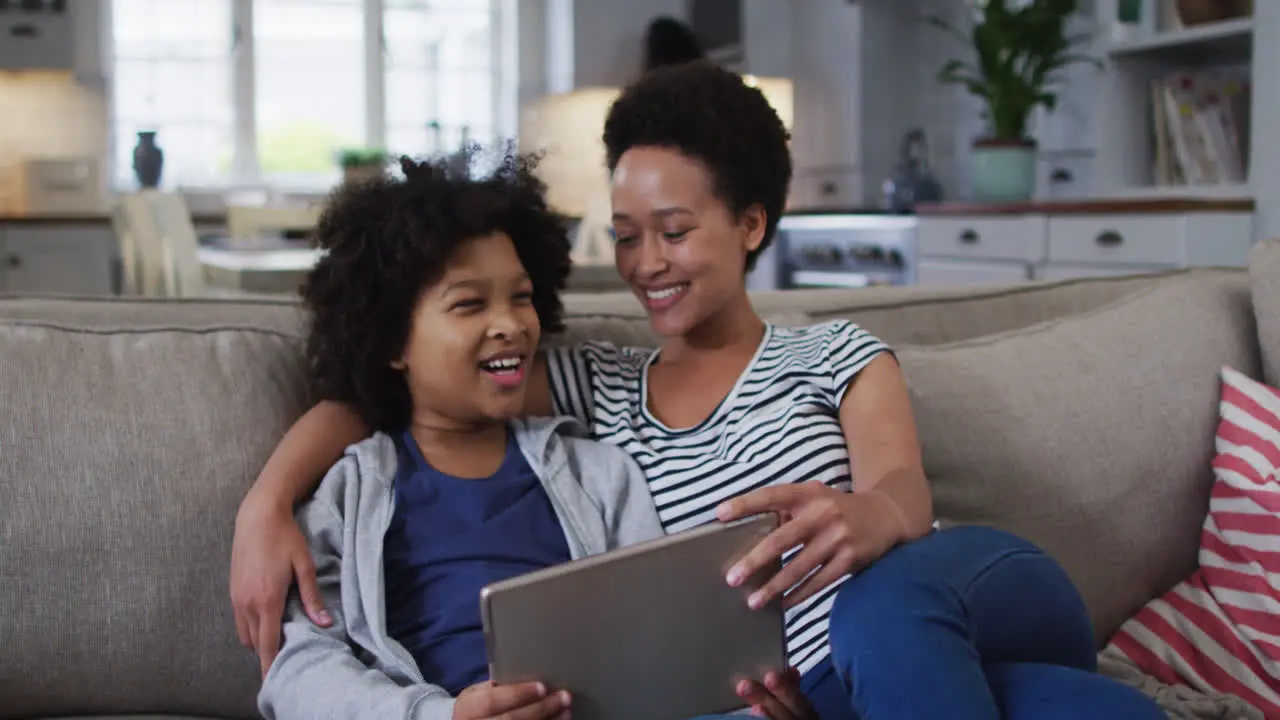 Mixed race mother and daughter using a digital tablet