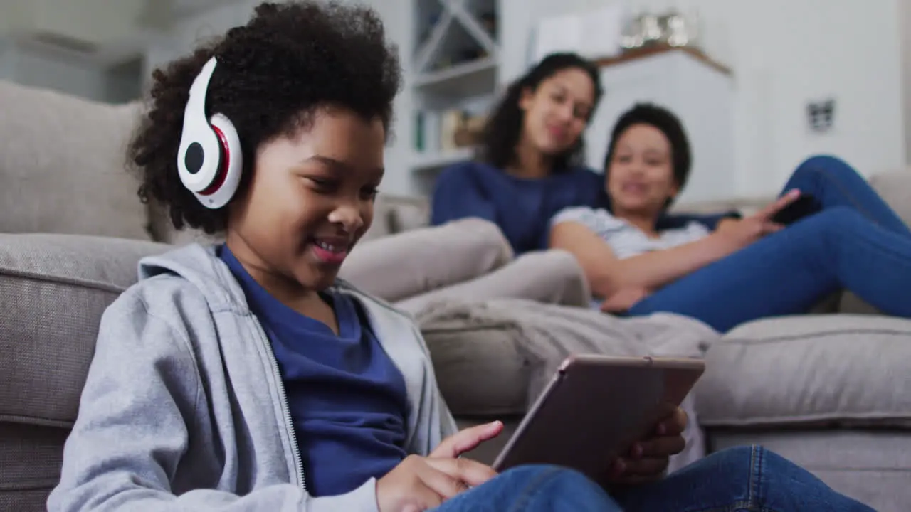 Mixed race girl using a digital tablet with headphones on