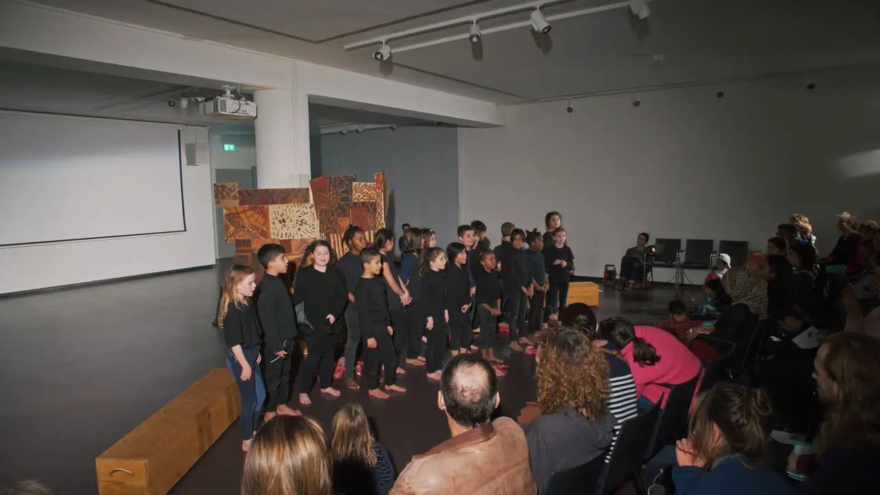 Children singing in a performance for their parents