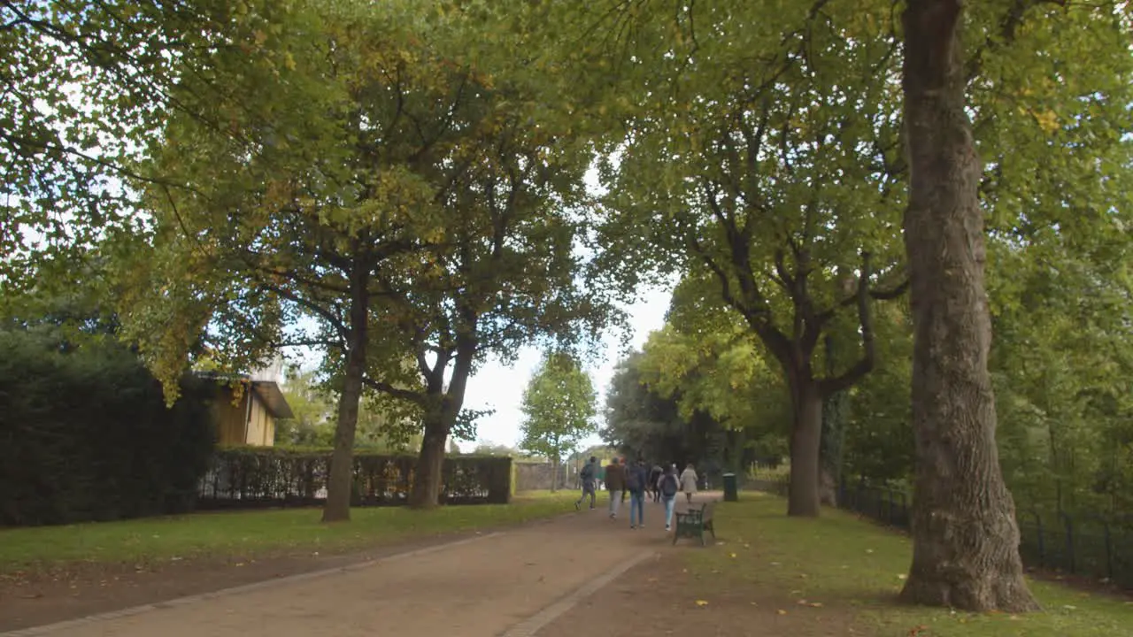 People Walking Through Bute Park In Cardiff Wales In Autumn 1