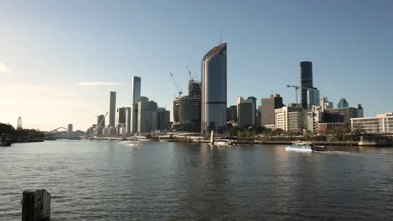 Wide view of Brisbane City in the afternoon light as a CityCat arrives at QUT Ferry Terminal Queensland Australia