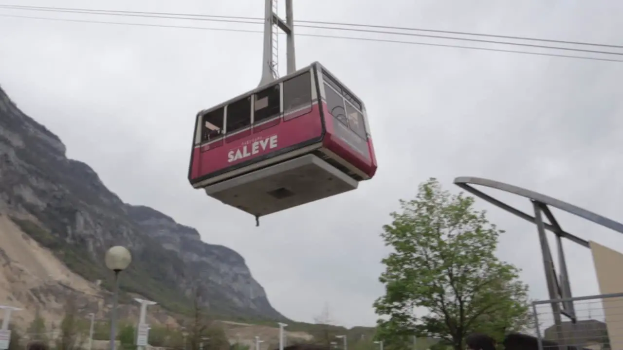 Salève cable-car leaving the bottom station up to the top on overcast day panning shot