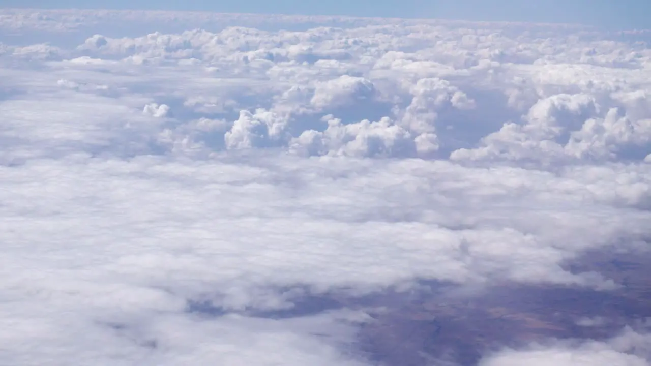 View of dense white clouds seen from the window of a passenger plane